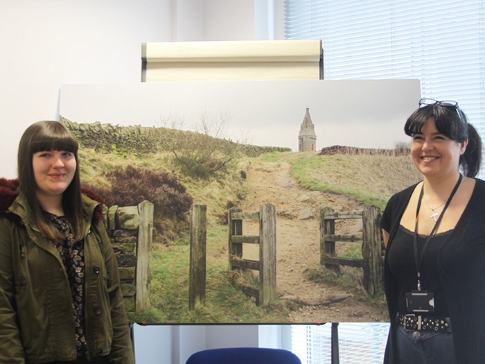 Level three photography students, Kayla and Michelle present one of their images to the Pennine Care NHS Foundation Trust 